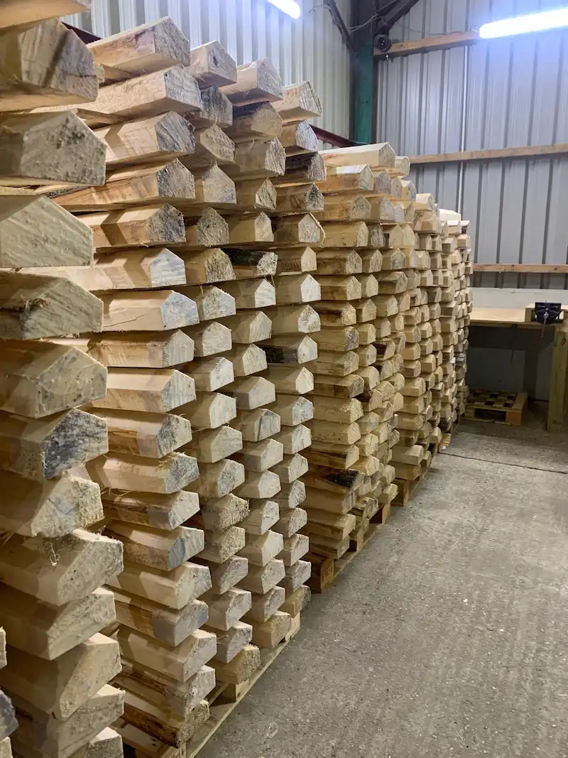 Stacked English willow cricket bat clefts in manufacturing warehouse ready for bat production
